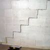 A diagonal stair step crack along the foundation wall of a  home