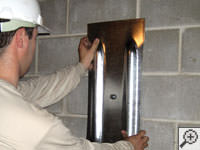Mounting a foundation wall plate for an earth anchor installation in .