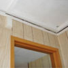 The ceiling and wall separating as the wall sinks with the slab floor in a  home