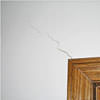 wall cracks along a doorway in a  home.