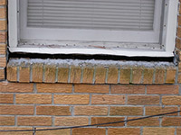 A window sill cracking and separating from the foundation wall in a  home.