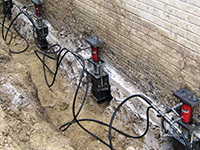 Using foundation push piers to lift a foundation during a repair in .