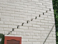 Stair-step cracks showing in a home foundation in 