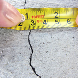 A crack in a poured concrete wall that's showing a normal crack during curing in 