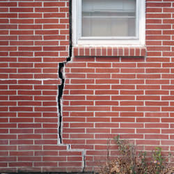 A foundation with a large crack that's wider at the top than on the bottom in 